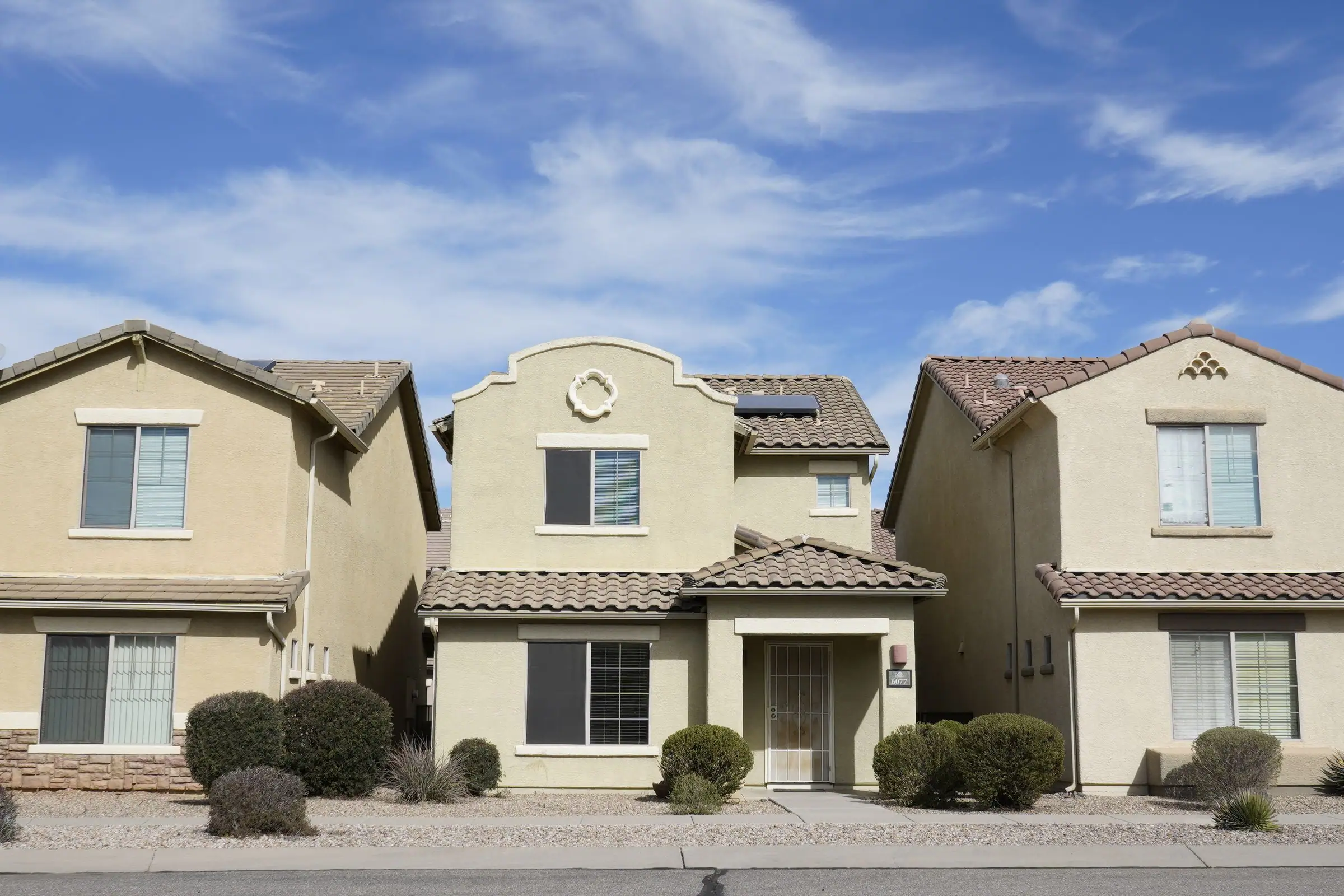 Row of two story stucco homes in an Arizona neighborhood