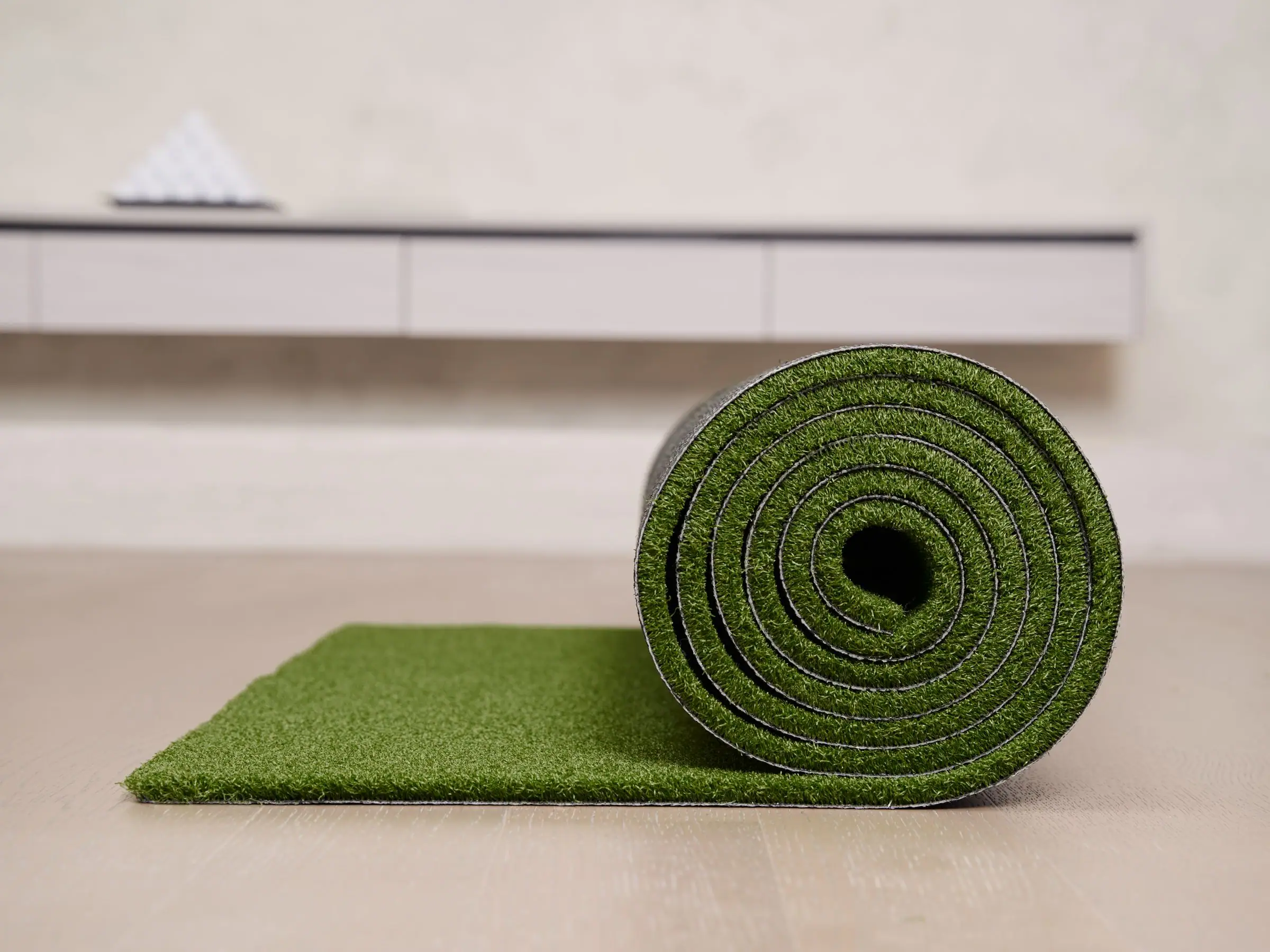 Roll of artificial turf on a floor