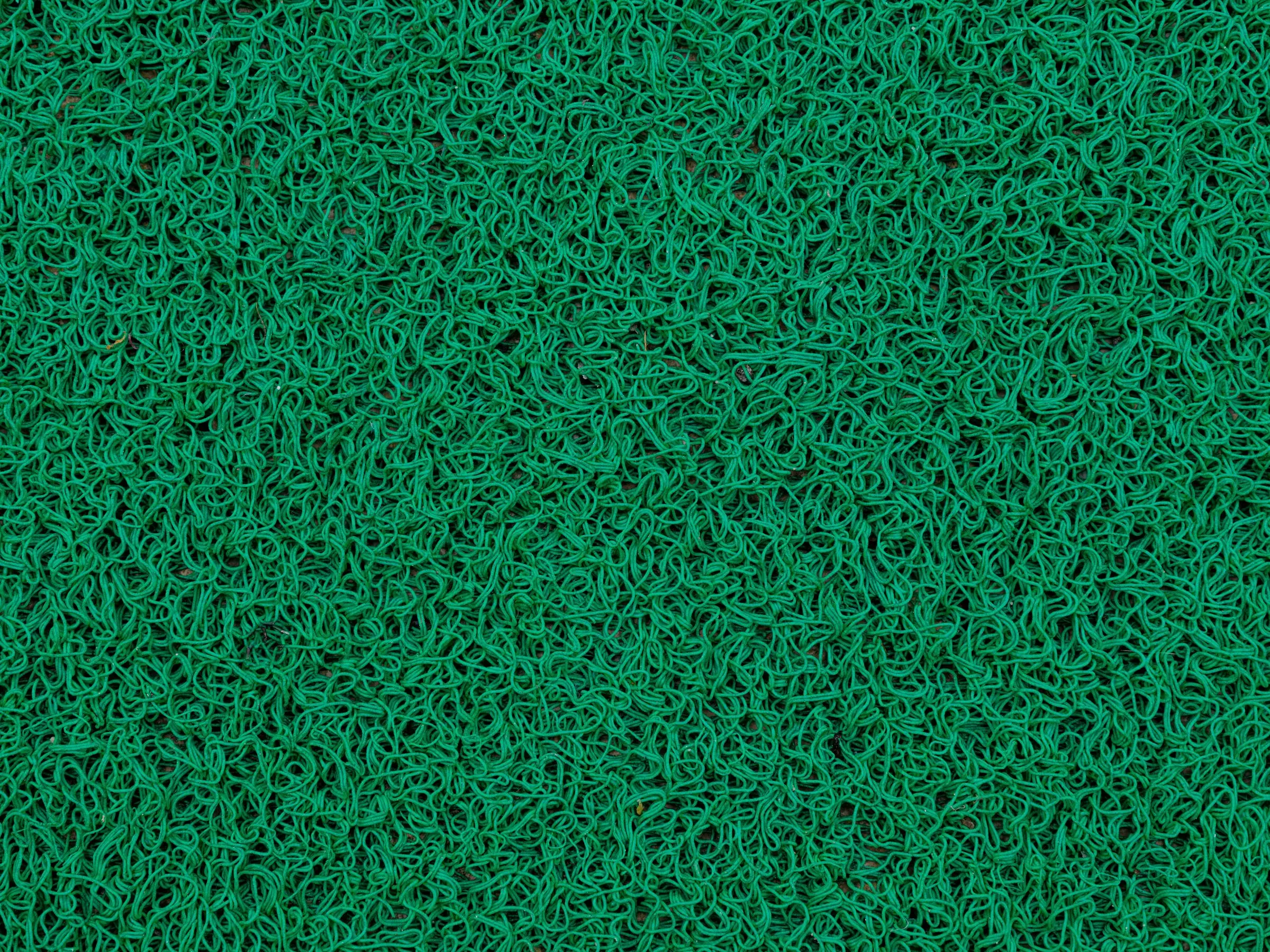 Even green artificial turf surface seen from above